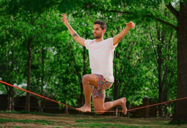 A man on a slackline in the park