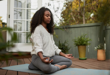 Woman meditating on yoga mat