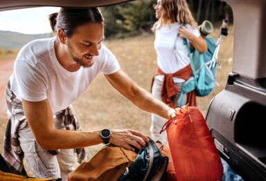 Friends packing their car to go camping