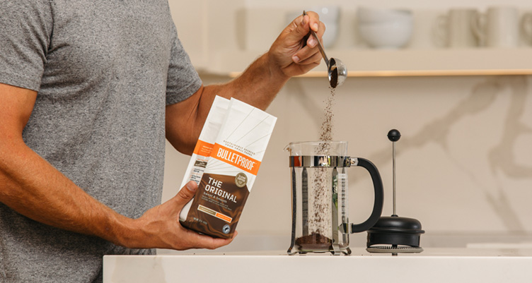 woman making french press with bulletproof coffee