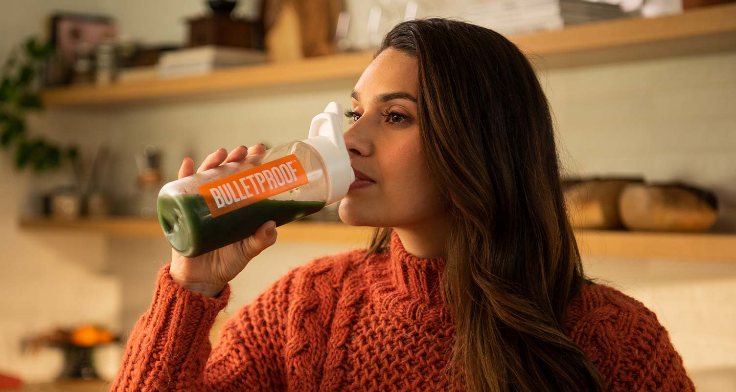 woman drinking greens