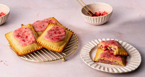 Keto pop tart on cooling rack next to bowl of crushed dried strawberries