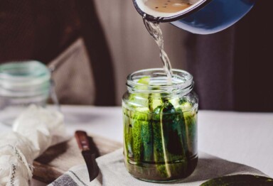 Pouring pickling juices in jar