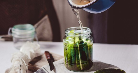 Pouring pickling juices in jar