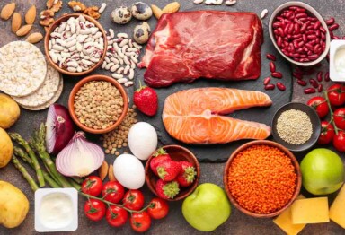 foods with a high satiety index on a counter. salmon, meat, vegetables, fruit, eggs