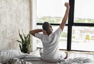 Male stretching in bed