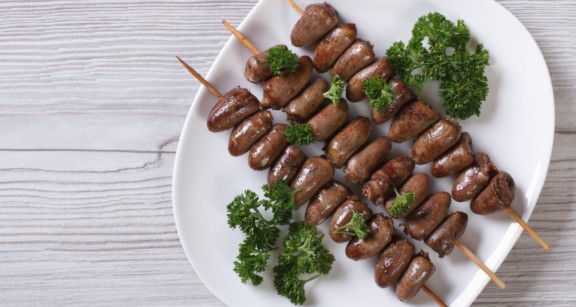 Chicken hearts on skewers with parsley