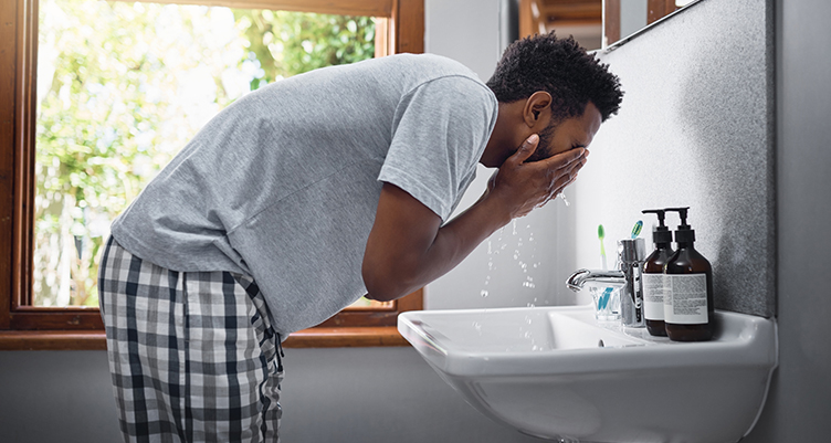 man washing his face