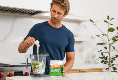 man adding collagen protein powder to a blender