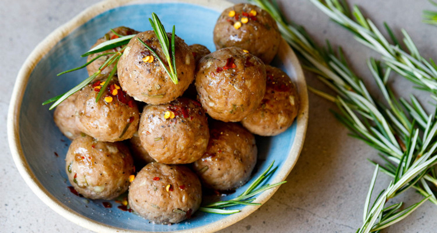 meatballs on a blue plate with veggies