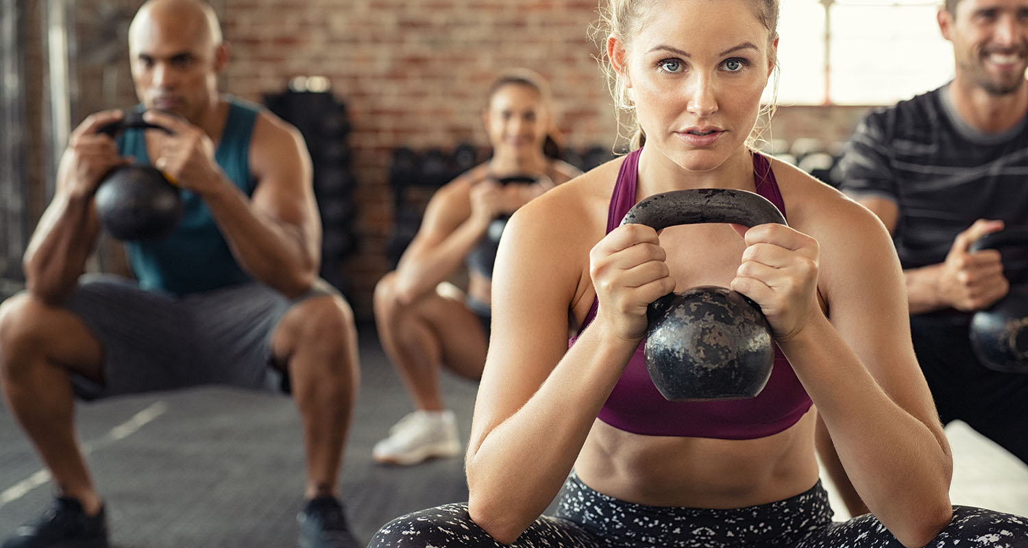 A fitness class working out with kettlebells