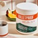 Hand scooping Bulletproof Innerfuel Prebiotic into coffee mug next to tub