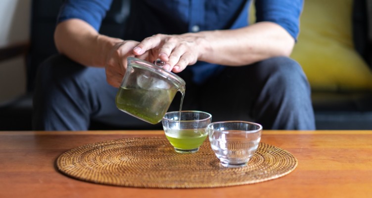 man pouring green tea