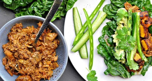 Mexican shredded beef next to white plate of vegetables