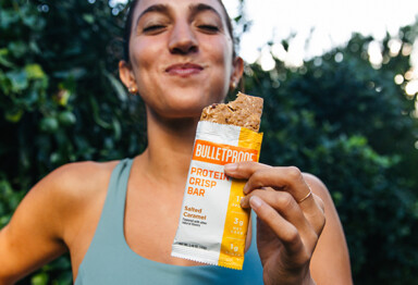 woman eating bulletproof protein crisp bar