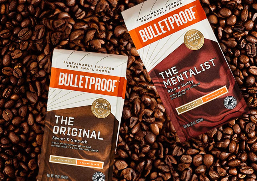 Bulletproof coffee packages, The Original and the Mentalist, laying on coffee beans.