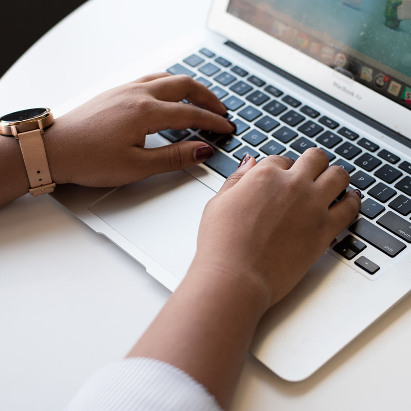 hands typing on a laptop