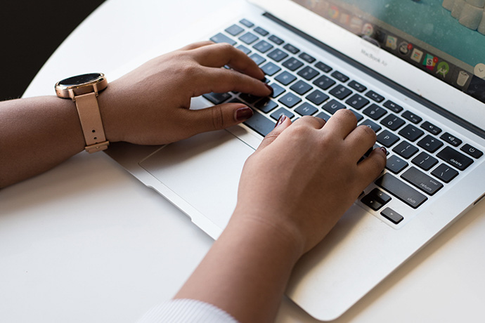 hands typing on a laptop