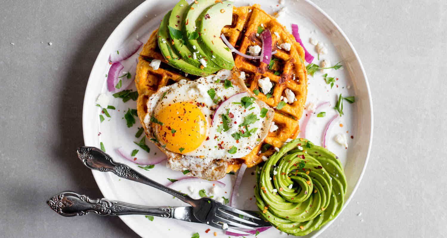 Gluten-free sweet potato waffle with eggs and avocado