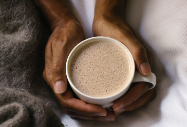 Hands holding cup of tea