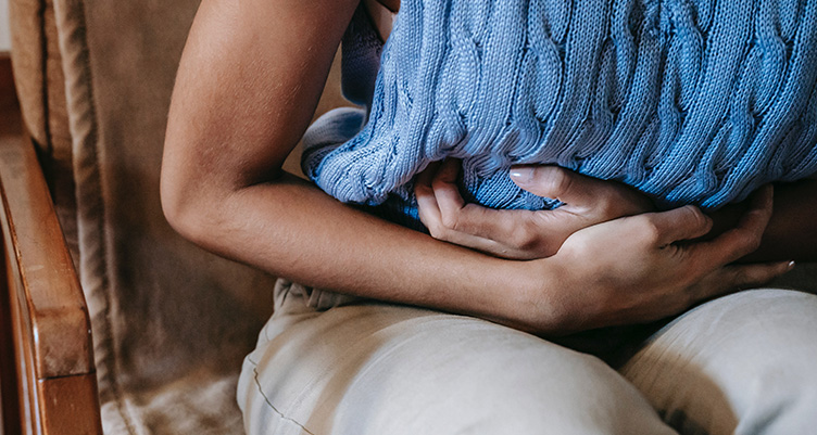 woman holding stomach in pain