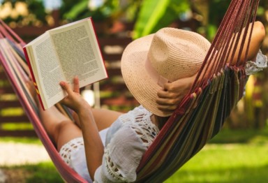 Woman reading outside during staycation