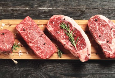 Several cuts of steak on a cutting board